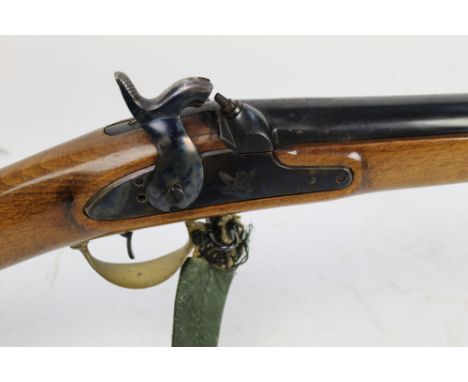 A Zoli 12 bore single barrelled percussion muzzle loading shotgun, with 32" barrel, stock fitted with a patch box and sling. 