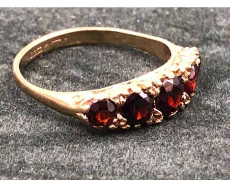 A 9ct GOLD HALLMARKED FIVE STONE GRADUATED GARNET CARVED HALF HOOP RING. FINGER SIZE Q. WEIGHT 3.02grms. 