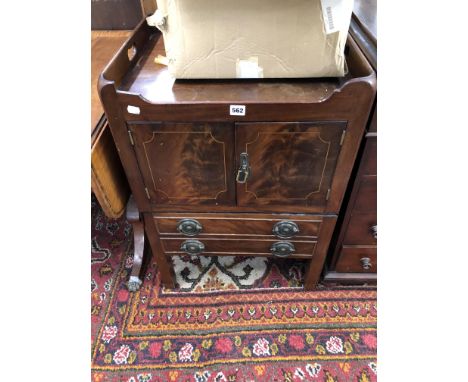 A GEORGE III MAHOGANY NIGHT TABLE WITH HANDLES PIERCED IN THE THREE QUARTER GALLERY OF THE TOP OVER LINE INLAID DOORS AND DRA