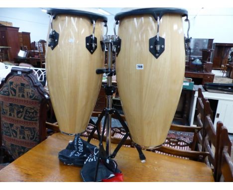 A PAIR OF TOCA HAND PERCUSSION BONGOS ON STAND WITH A DVD INSTRUCTION MANUAL. 