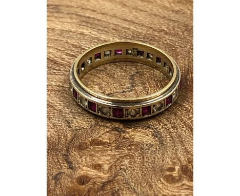 A VINTAGE GARNET AND CZ FULL ETERNITY RING, STAMPED 9ct AND ASSESSED AS 9ct GOLD. FINGER SIZE R. WEIGHT 3.45grms. 
