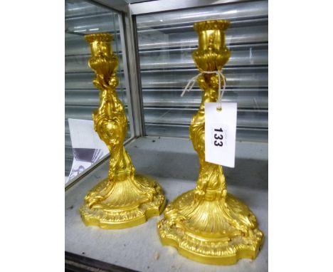 A PAIR OF 19th C. GILT BRONZE CANDLESTICKS WITH THE NOZZLES SUPPORTED BY THREE NAKED FIGURES WITH FOLIATE FEET RUNNING DOWN T
