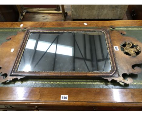 A GEORGE III MAHOGANY CUT WORK FRAMED MIRROR CRESTED WITH A ROUNDEL PIERCED ABOUT THE GILT PRINCE OF WALES FEATHERS