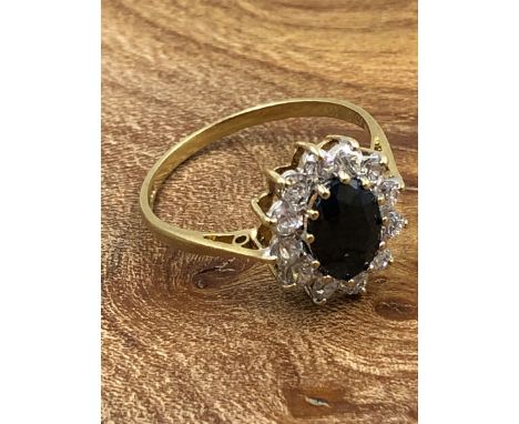 A 9ct HALLMARKED GOLD CZ CLUSTER RING IN A CLAW SETTING. FINGER SIZE P 1/2. WEIGHT 2.34grms. 