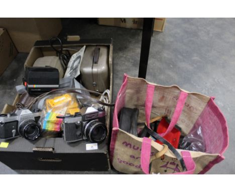 Box and bag of vintage cameras and accessories to include Pentax, Praktica, Polaroid, and projectors  