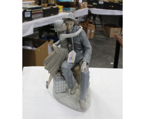 Large Lladro figurine, seated man with lantern and lady  