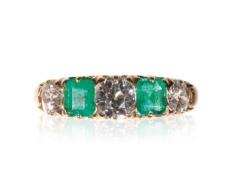 FIVE STONE EMERALD AND DIAMOND RING, three brilliant-cut diamonds, divided by two princess-cut emeralds, on an unmarked yello