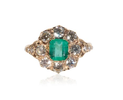 EMERALD AND DIAMOND CLUSTER RING, the claw-set emerald, surrounded by a border of eight brilliant-cut diamonds, on an 18ct ye