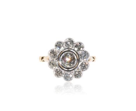 DIAMOND CLUSTER RING, the collet-set diamond approx .65 ct, surrounded by a border of ten further diamonds, approx 1.75ct tot