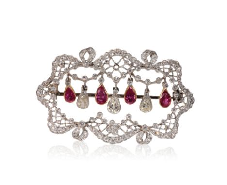 DIAMOND AND RUBY PLAQUE BROOCH, three pendeloque diamonds and four pendeloque rubies, suspended to the centre of an open-work