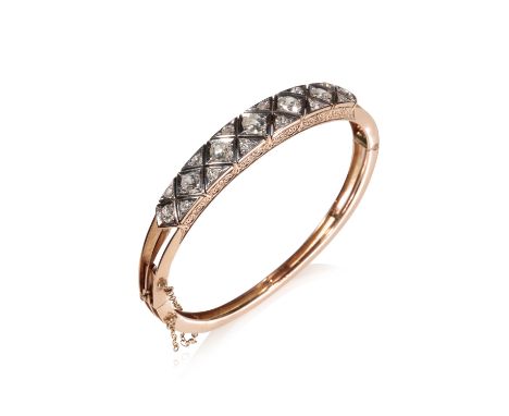 VICTORIAN DIAMOND SET BANGLE, seven graduated cushion-cut diamonds, divided with twelve further diamonds, set on an unmarked 