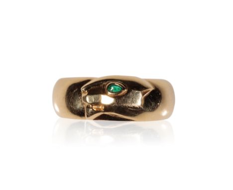 CARTIER GOLD PANTHERE RING, the wide band with a panther head, set with a single emerald eye, inscribed " Cartier 750" "1996"