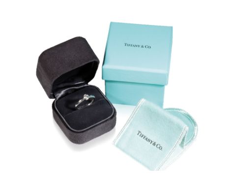 TIFFANY DIAMOND RING, the diamond .23ct, collet-set, on a platinum shank, ring size k, in original Tiffany presentation case 