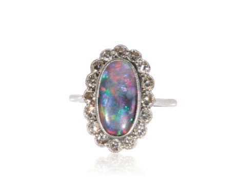 OPAL AND DIAMOND RING, the black opal, surrounded by a border of sixteen round-cut diamonds, on a platinum shank, ring size M