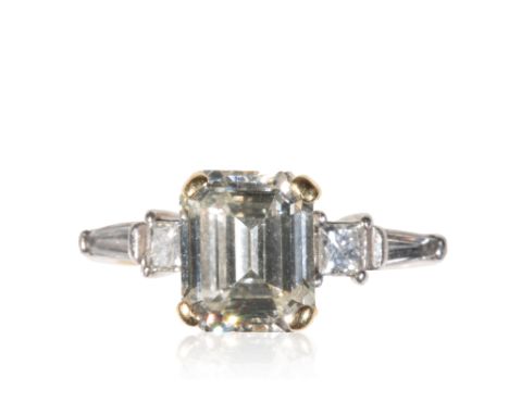 DIAMOND DRESS RING, the emerald-cut diamond approx 2.50ct, flanked either side by a single emerald-cut and tapered baguette-c