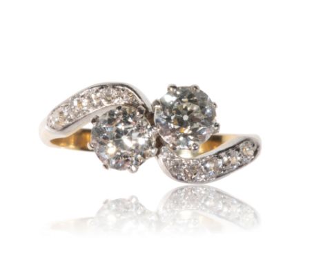 DIAMOND CROSS OVER RING, two brilliant-cut diamonds,approx .50ct each, diamond cross-over set, on an unmarked yellow metal sh