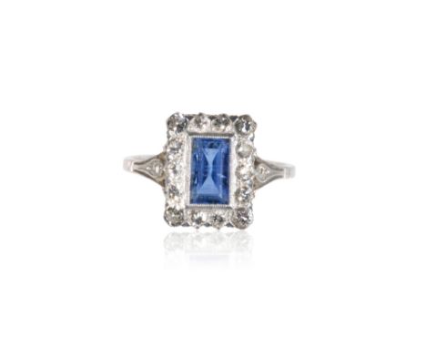 SAPPHIRE AND DIAMOND RING, the sapphire surrounded by a border of pave-set diamonds, on a platinum shank, ring size H