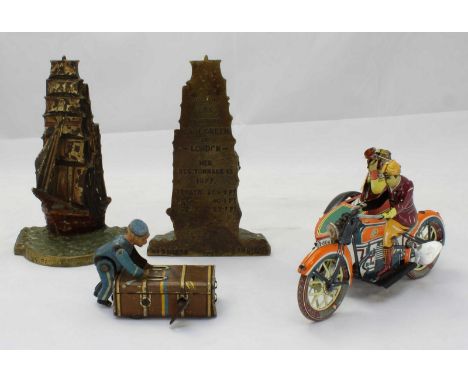 A clockwork toy porter and trunk and a clockwork motorcycle and sidecar, together with a pair of painted brass book ends mode