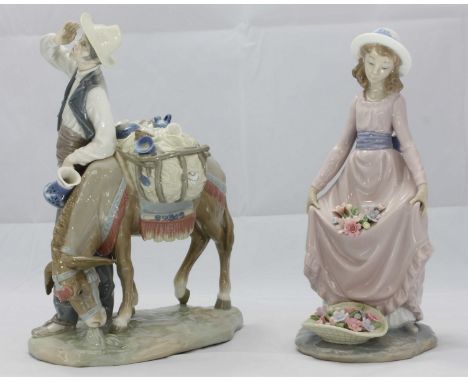 Two Lladro ceramic figures; 'Typical peddler' reference 4859 and a young girl holding flowers, reference 5027, both in origin