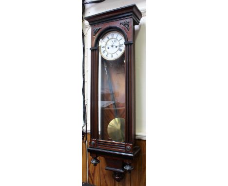 An early 20th century Vienna wall clock, walnut case, enamel dial with Roman numerals, pendulum and brass weights, 105cm