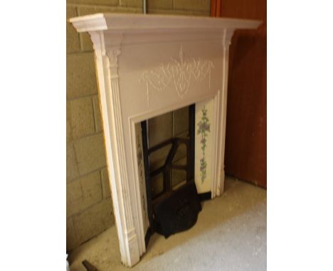 A large wrought iron fire surround, painted in white with 10 decorative ceramic tiles depicting floral designs, with some loo