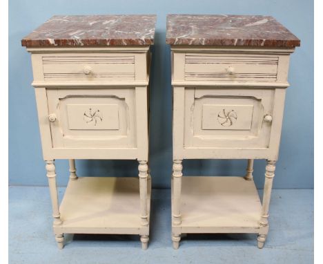 A pair of painted French bedside tables, both with marble tops and single drawer, above a single cupboard leading to an open 