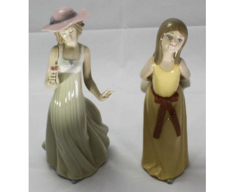 A Lladro ceramic figure of a girl in a yellow dress, together with a NAO figure of a girl holding a flower. Tallest figure me