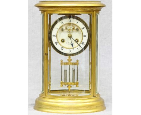 A late 19th century French Brass mantle clock by C.Jackman of Paris, the oval bevelled glass case housing an Anchor escapemen