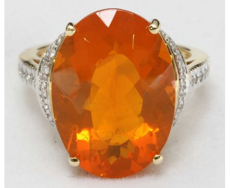 An 18ct yellow gold, diamond and 'Fire Opal,' dress ring, centrally claw-set a large oval faceted orange 'Fire Opal,' measuri