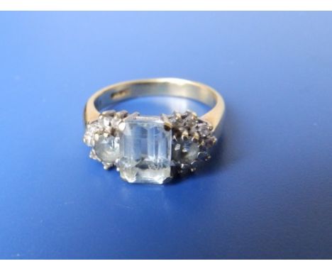 An aquamarine & diamond dress ring.