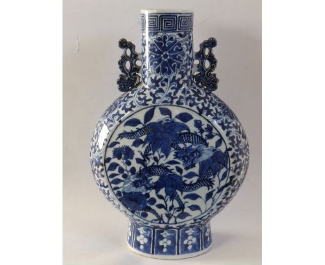 A Chinese blue & white porcelain moonflask vase, having flattened scroll pierced handles, two dragons painted to either side 