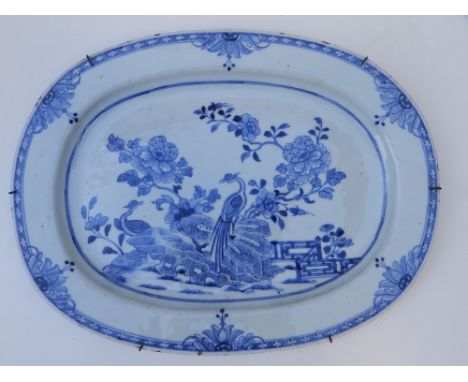 An early 19thC Chinese porcelain serving dish, of rounded rectangular form, decorated with two exotic birds alongside large f