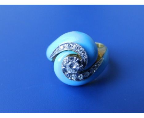 A diamond set crossover style ring with turquoise enamelled shoulders – '750'. Finger size J.