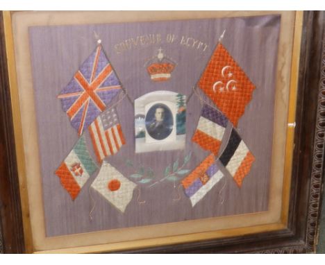 A framed WWI souvenir panel of Egypt with military photo to centre and flags.