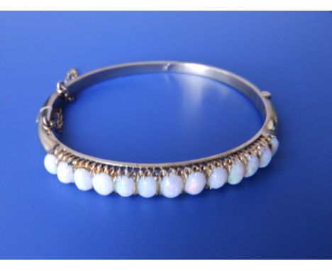 An opal set 9ct bangle.