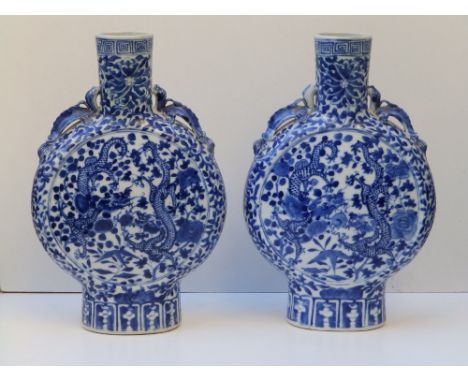 A pair of Chinese blue & white porcelain moonflask vases, having dragon handles to shoulders, a pair of dragons painted to ei