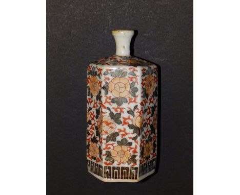 A Chinese hexagonal porcelain bottle vase decorated in the Imari palette with flowers and scrolls, 6” high.