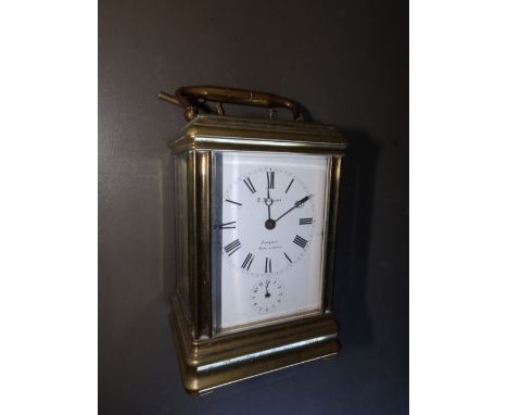 A French brass alarum carriage clock striking on a gong, retailed by F. Phillips , Aldershot, 5.3” excluding handle.