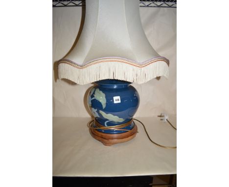 A modern French ceramic table lamp in the form of a ginger jar, with cream silk shade, on turned wooden base.