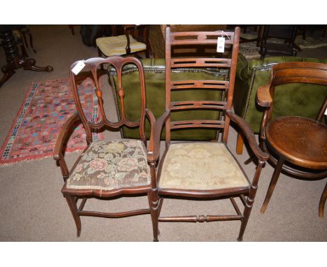 Two Edwardian inlaid mahogany elbow chairs, one ladder back; the other with decorative paterae decorated splats.