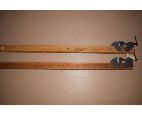 A pair of metal and wooden sash cramps, by Woden.