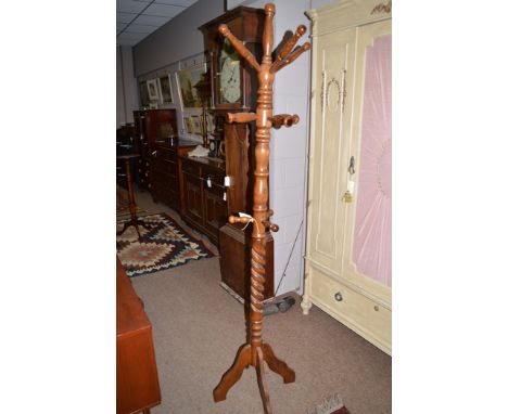 A turned stained wood hat and coat stand, 188cms high.