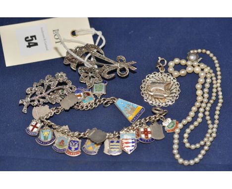 A marcasite set silver mounted and flower pattern brooch; a charm bracelet with enamel city crest charms; a silver galleon pa
