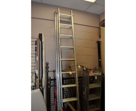 A modern extending three section aluminium ladder of thirty treads.