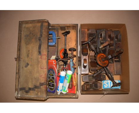 A collection of old carpentry tools, comprising: mainly block planes in wood and hand operated drills; and a joiner's tool bo