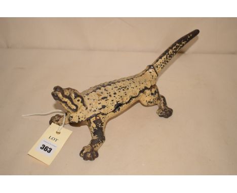 An early 20th Century white painted cast iron nut cracker in the form of an alligator.
