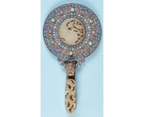 A Chinese carved jade, enamel decorated white metal and coloured cabouchon set hand mirror, probably 19th Century, the back i