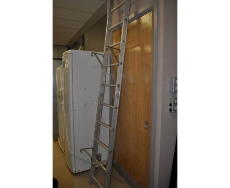 An aluminium ladder in two double sections.