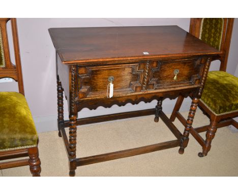 An oak side table, fitted two frieze drawers, raised on turned bobbin legs, 91cms wide.