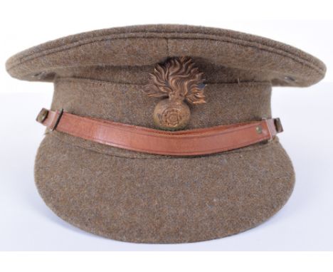 Royal Fusiliers Service Dress Peaked Cap, khaki stiff top peaked cap fitted with brass other ranks cap badge, thin brown leat